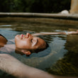 Load image into Gallery viewer, Lady soaks in hot springs on Hike & Seek Mornington Peninsula Day Tour