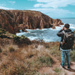 Load image into Gallery viewer, Guy takes photo of Bass Strait at Phillip Island Hike & Seek